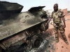 Nigerian wheeled armoured personnel carrier Piranha I Grizzly picture. An African Union Mission in the Sudan (AMIS) peacekeeper from Nigeria points to the blast point of a rocket-propelled grenade on a destroyed armoured personnel carrier at Haskanita military group site (MGS), October 1, 2007. Twenty AU soldiers were killed or injured and nine missing after a "deliberate and sustained" assault on the Haskanita base in Darfur on Saturday night by armed men in 30 vehicles, who looted and destroyed the base, the African Union said.