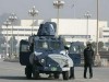 Pakistani Army wheeled armoured vehicle picture . Police stand beside an armoured personal carrier (APC) in front of the President House in Islamabad December 15, 2007. Pakistani President Pervez Musharraf lifted emergency rule on Saturday in a move Western nations hope will stabilise the nuclear-armed state as Islamic militant violence spirals.