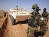 Wheeled Armoured personnel carrier Grizzly Piranha I Mowag UNAMID picture. Members of the African Union Mission in Sudan (AMIS) stand in front of an armoured personnel carrier (APC) at a firing range approximately 20 km (12 miles) outside El Fasher, the administrative capital of north Darfur, November 8, 2007. Newly arrived troops from two extra battalions of Rwandan and Nigerian soldiers have recently arrived in Sudan's war-torn western region to boost the already 7,000 personnel on the ground ahead of a planned handover from AMIS to a joint African Union-United Nations Mission known as UNAMID consisting of 26,000 personnel at the end of 2007. The troops were undertaking weapons training as part of an APC training course before their deployment to mission groups sites across Darfur. 