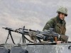 Turkish army soldier picture. Turkish soldiers, followed by an armoured personnel carrier (APC), patrol a road surrounded by rugged mountains in the south-eastern Turkish province of Sirnak, bordering Iraq, November 8, 2007.