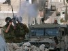 An Israeli soldier fires tear gas during an army raid in the Al Ain refugee camp in the West Bank town of Nablus, Thursday, Sept. 20, 2007. Residents of the crowded refugee camp outside of Nablus said they were running out of food and water on Thursday, as an Israeli army raid against Palestinian militants raged for a third day. The army is allowing food, medicine and ambulances into the Ein Bet Ilmeh camp, military spokesman Zidki Mamman said. But with a tight curfew clamped on the camp since Tuesday, some of the 5,000 residents said they couldn't leave their homes to buy food. Israeli soldiers picture